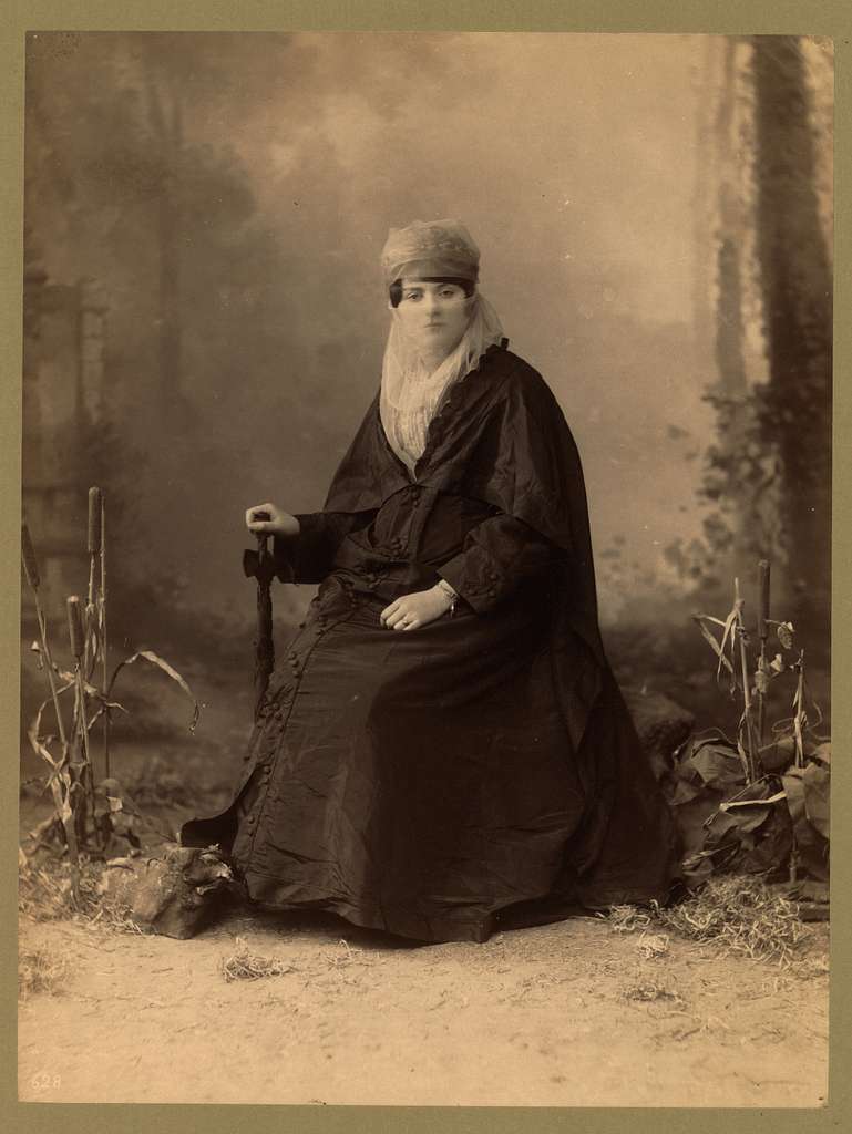 Turkish Woman Full Length Portrait Seated Facing Front Holding