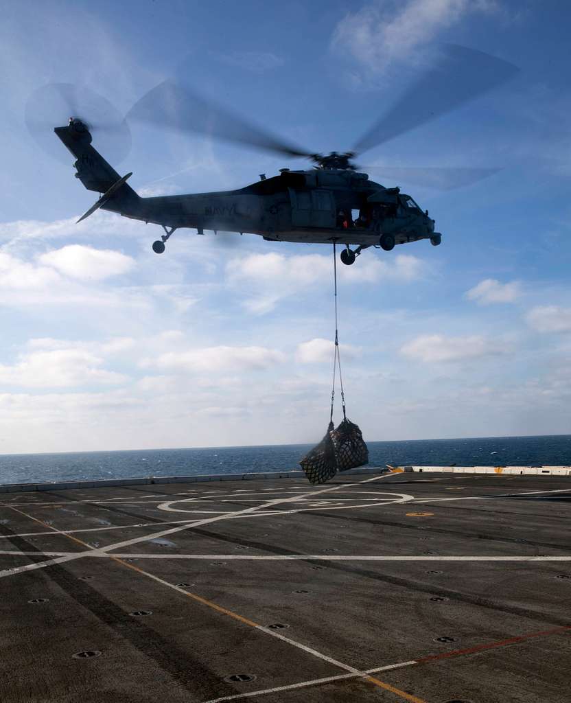 An MH 60S Seahawk Helicopter Delivers Cargo Pallets NARA DVIDS