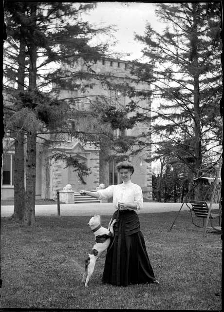 Mrs. B.R. Hepburn and dog standing in front of Rickarton Castle, Picton ...