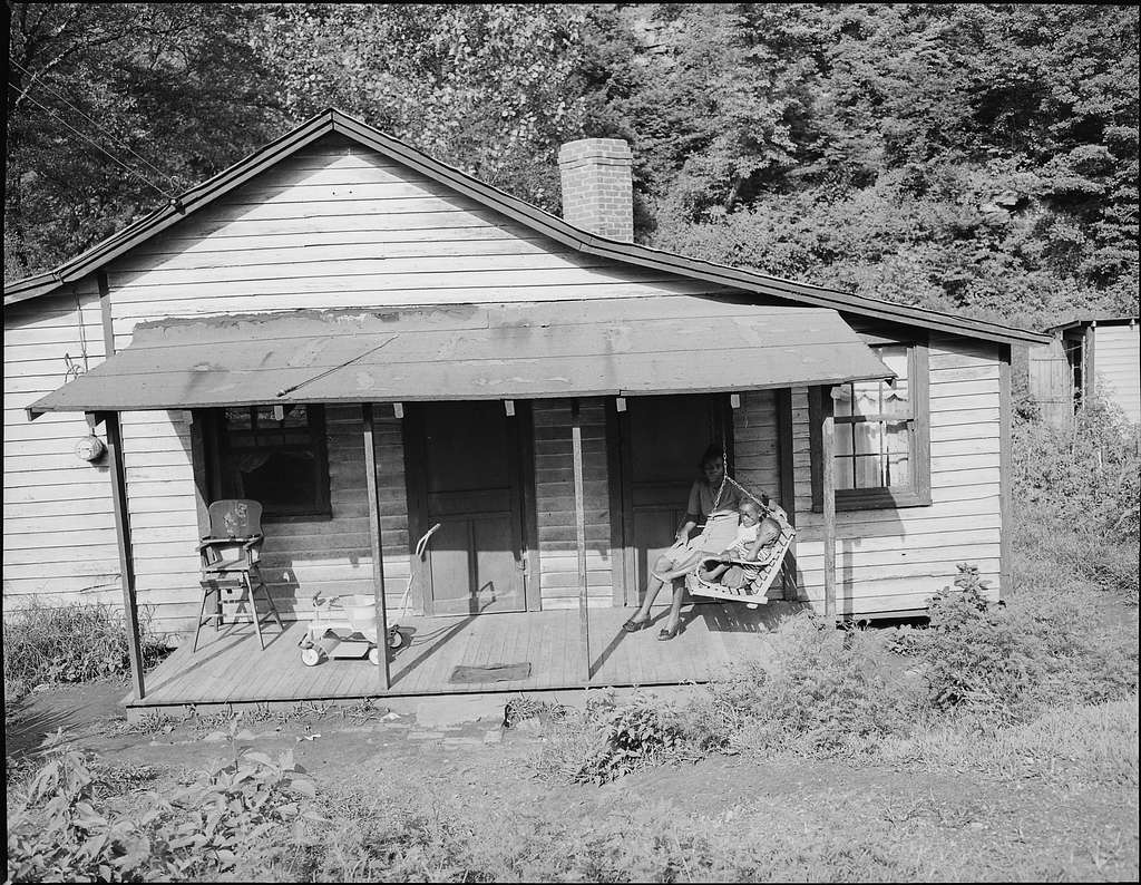 Mrs. Beulah Wady, wife of miner, and children on front porch of their ...