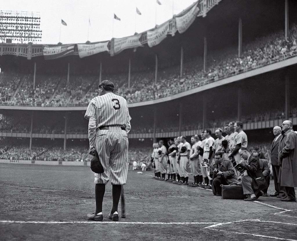 Babe Ruth in baseball uniform standing in dugout Stock Photo - Alamy