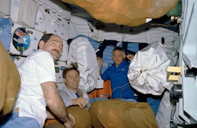 STS-27 Pilot Gardner works with cameras on aft flight deck at window W8 ...