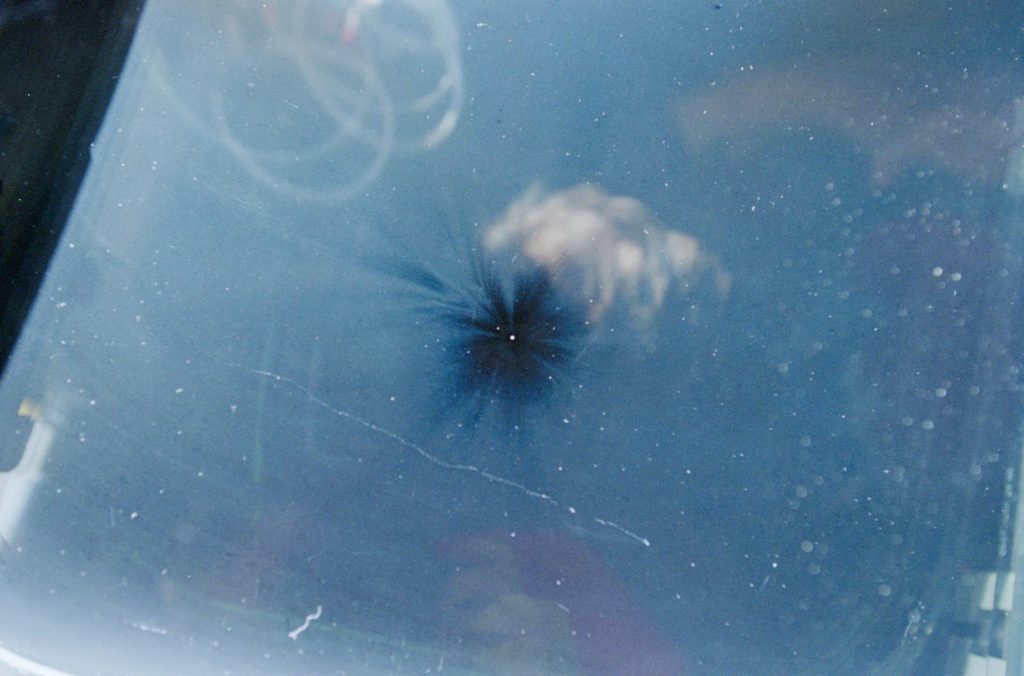 Views of the overhead flight deck window showing debris impact damage ...