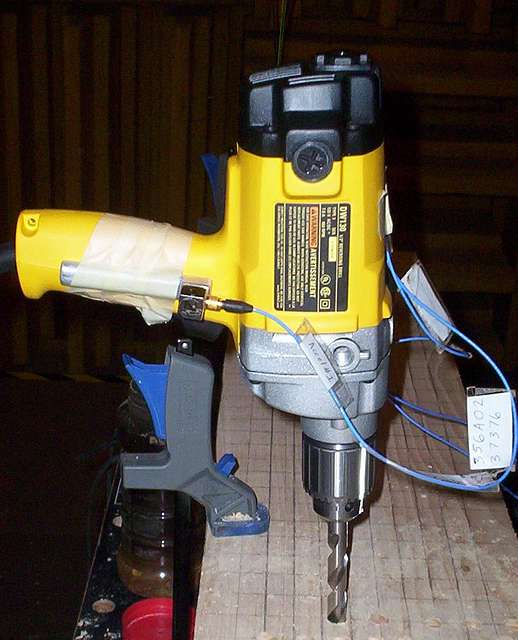 DeWalt DW130 loaded A drill is being used to drill a piece of