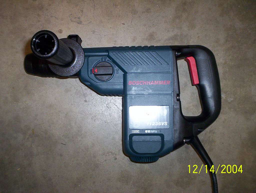 Bosch 11236VS loaded A drill is laying on the floor next to a