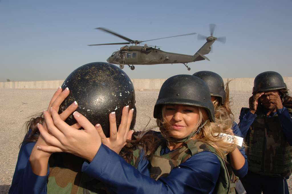 A Dallas Cowboys Cheerleader stands next to an Australian SAS