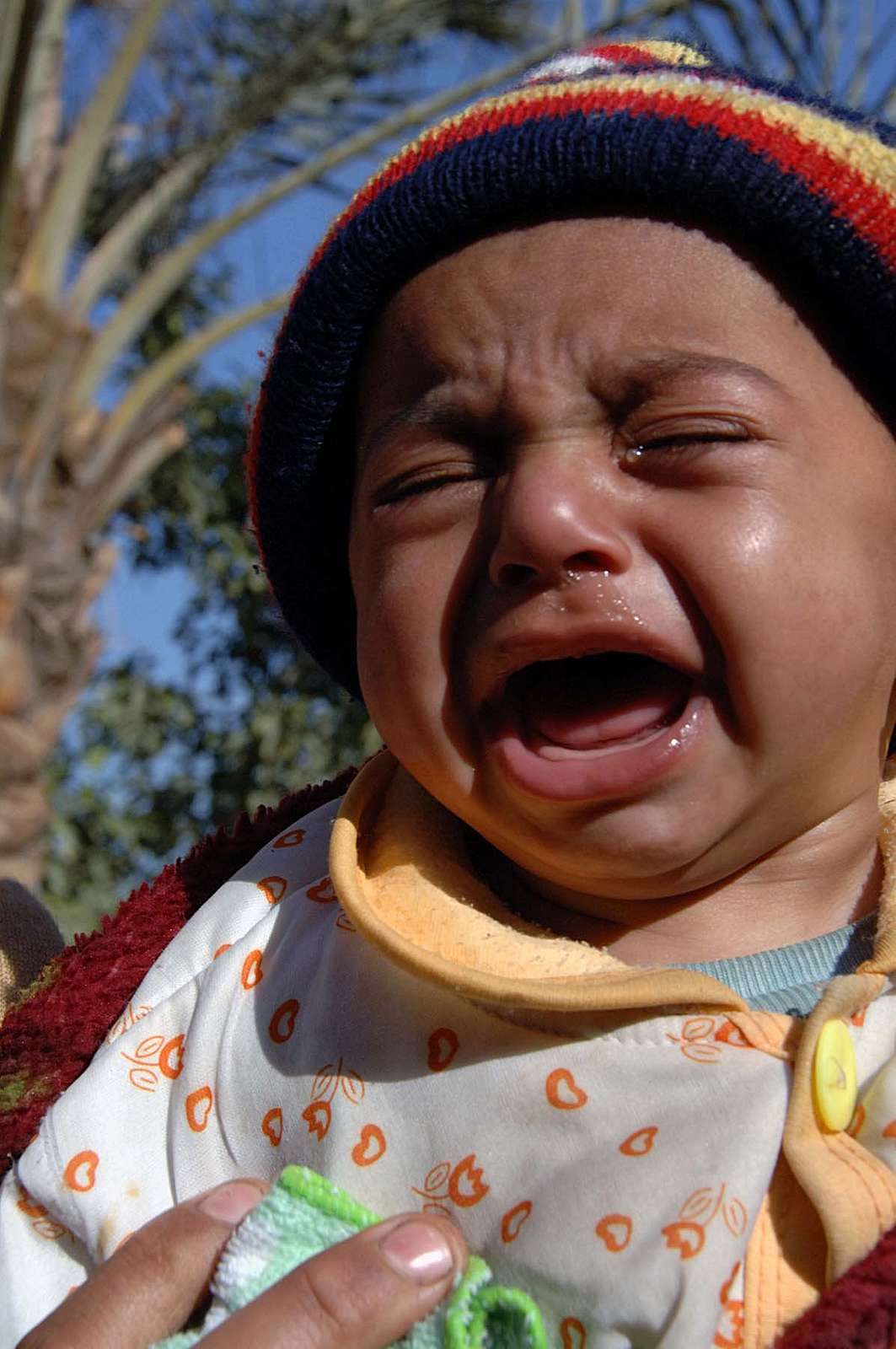 A toddler cries before receiving medical attention - NARA & DVIDS ...