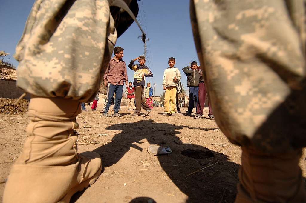 A group of young boys watch as U.S. Army Soldiers from - NARA & DVIDS ...