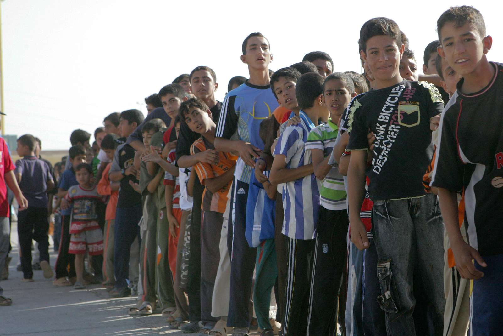 Iraqi children line up to enter the Mulaab Soccer Stadium - NARA ...