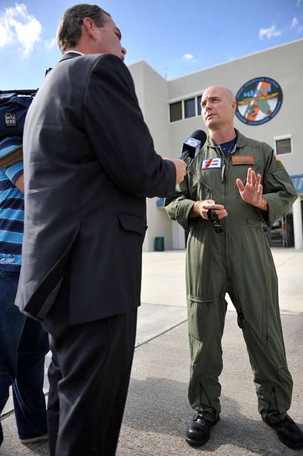 ESPN sports analyst Ron Jaworski, left, shows his Super Bowl ring to  Engineman 1st Class Brad Vincent, assigned to the littoral combat ship USS  Freedom (LCS 1), during a Monday Night Football