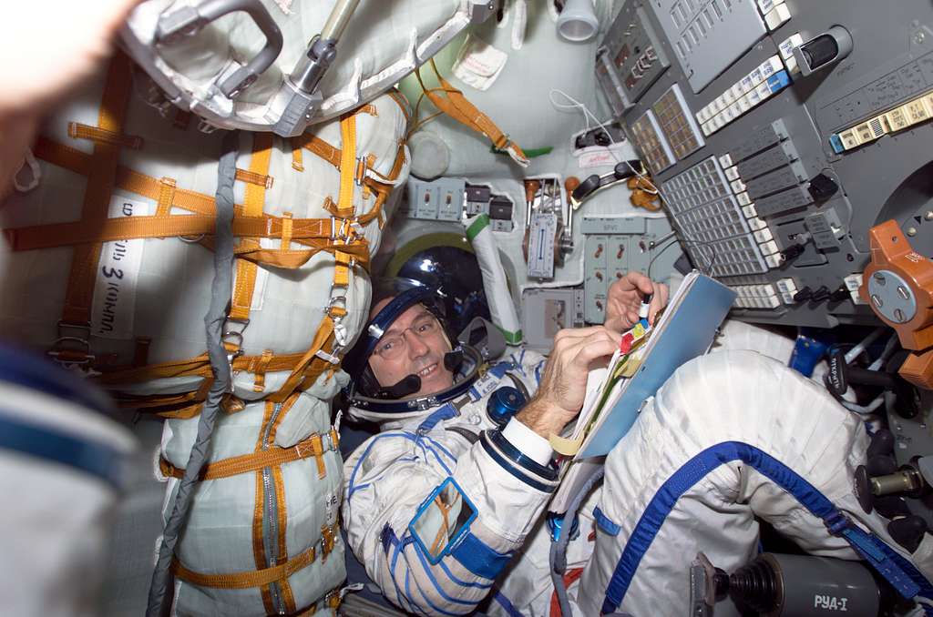 Walz seated in the Soyuz 3 capsule during Expedition Four rescue craft ...