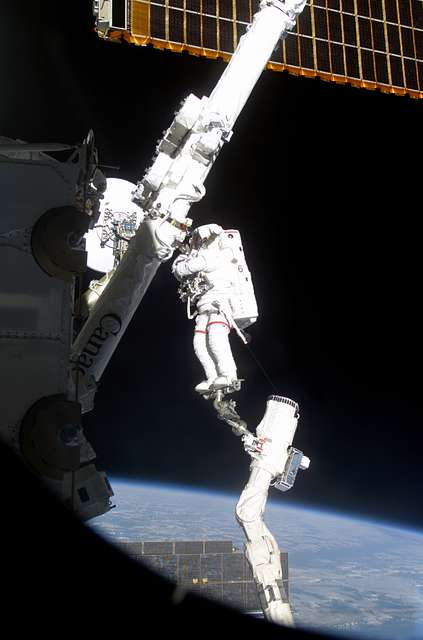 MS Hadfield works on the SSRMS in the SLP during the first EVA for STS ...