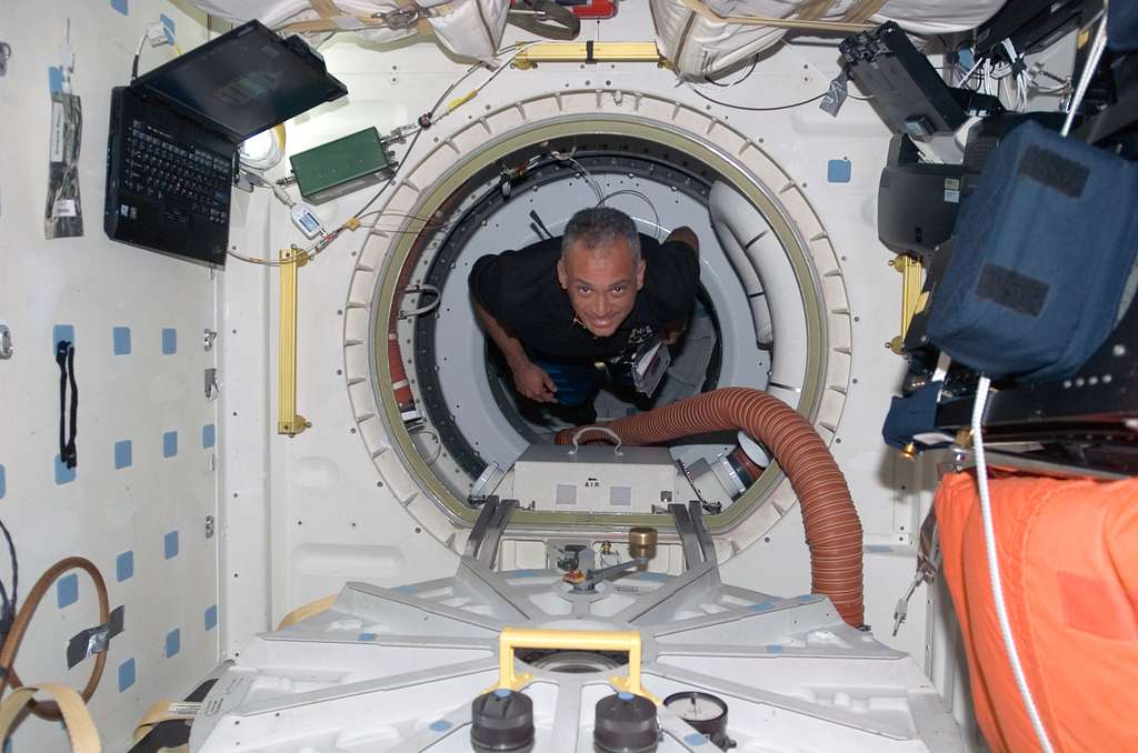 astronauts floating in space shuttle