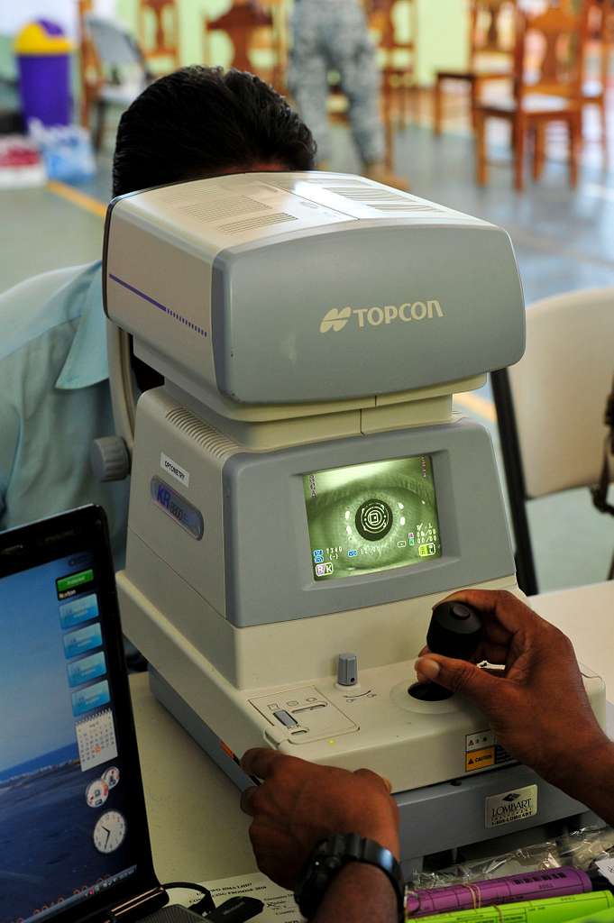 A Costa Rican man receives an eye scan from a health - NARA