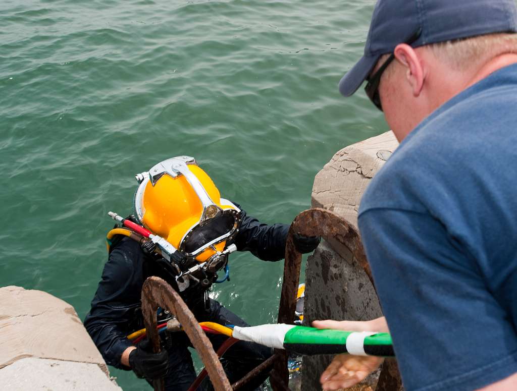 Navy diver ensures a proper seal on the Kirby Morgan 37 di…