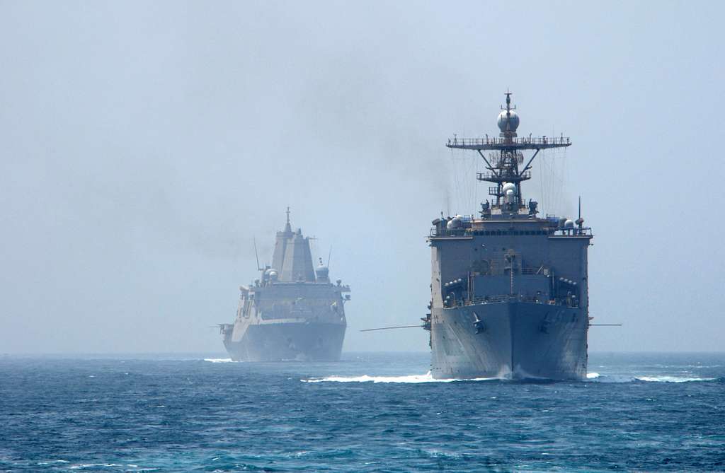 The amphibious dock landing ship USS Comstock, right, - NARA & DVIDS ...