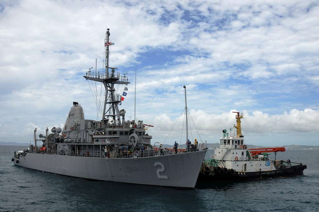 A tug boat pulls the mine countermeasures ship USS - NARA & DVIDS ...