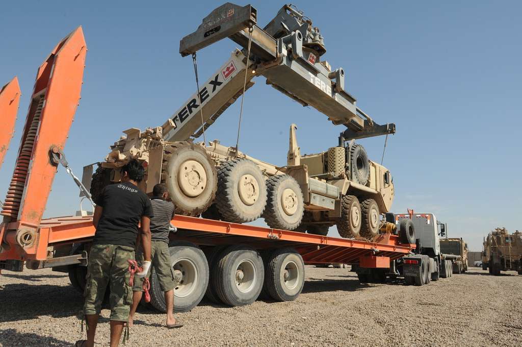 A crane is used to lift a canister containing a MIM-104 Patriot