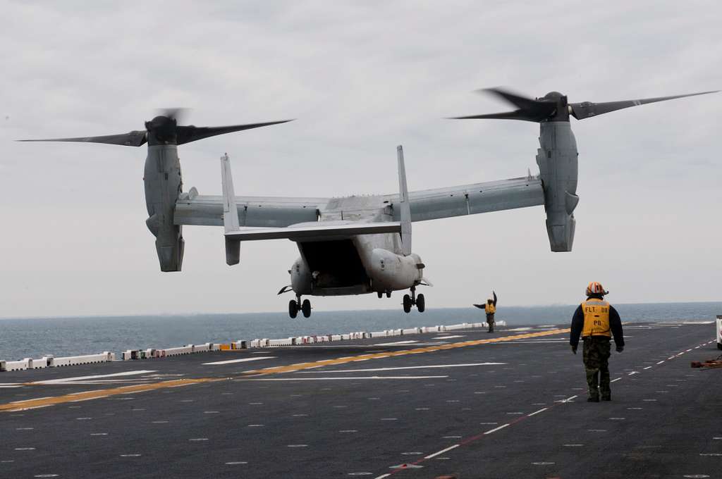 An MV-22 Osprey lands on the flight deck of the amphibious - NARA ...