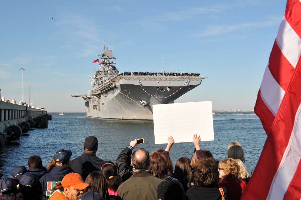 A crowd cheers as the amphibious assault ship USS Bataan - PICRYL