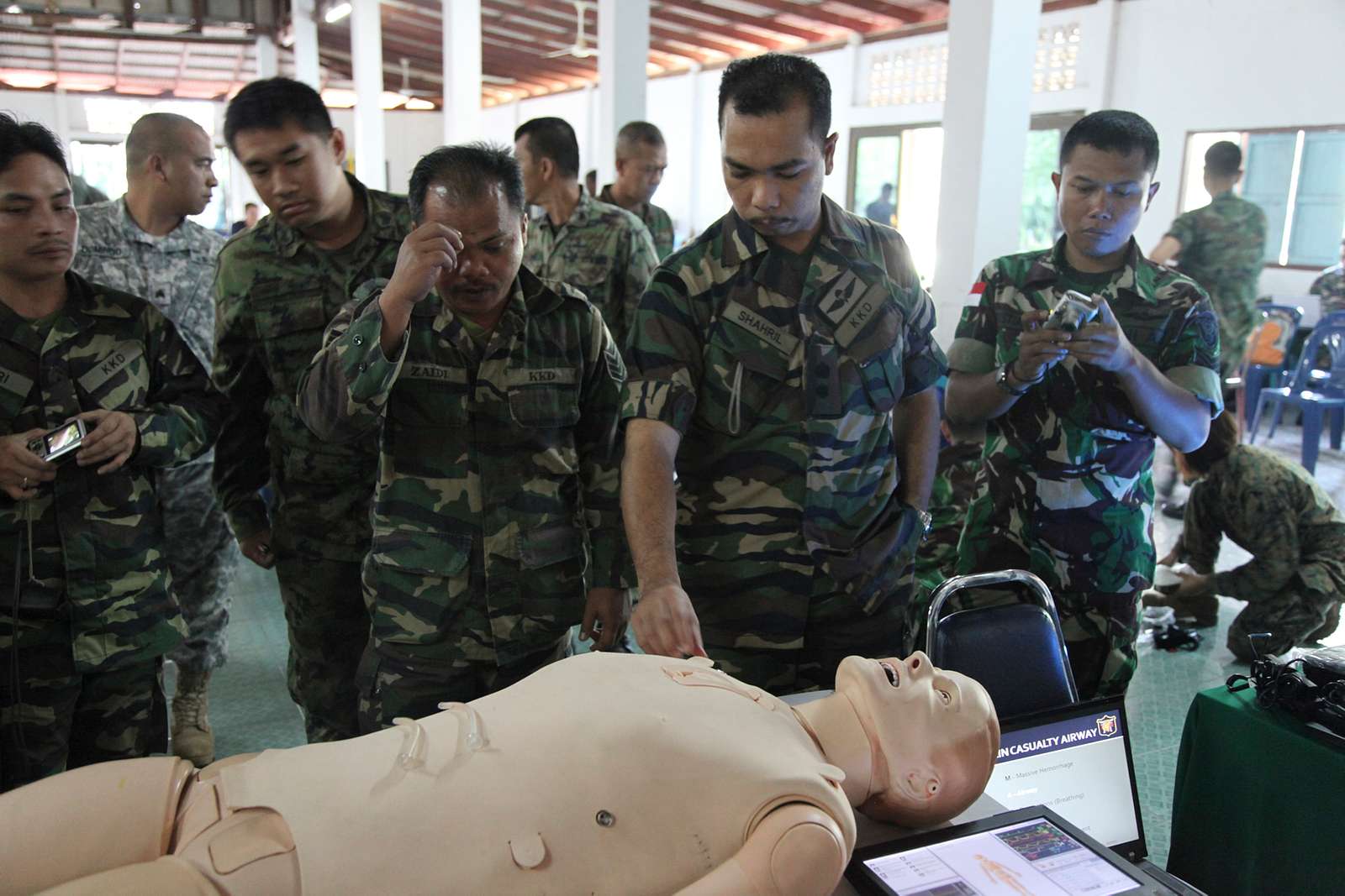 Indonesian and Malaysian service members examine the - NARA & DVIDS ...