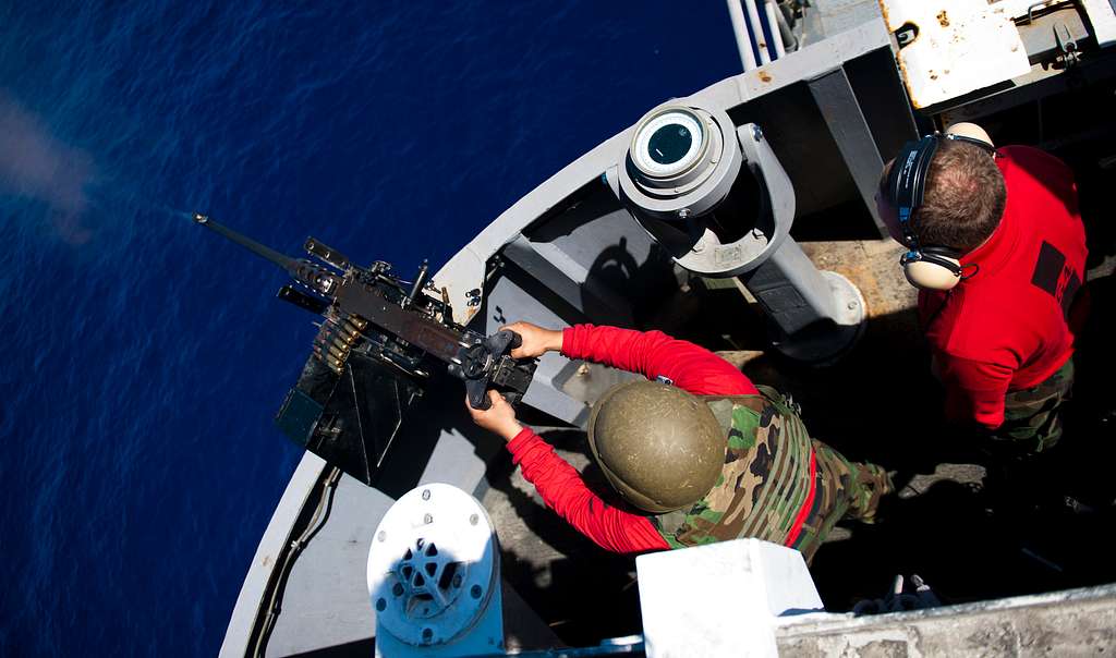 A sailor fires a .50-caliber machine gun during a live-fire - PICRYL ...