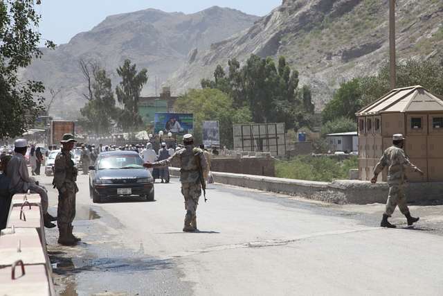 An Afghan Border Police officer directs a vehicle to - NARA & DVIDS ...