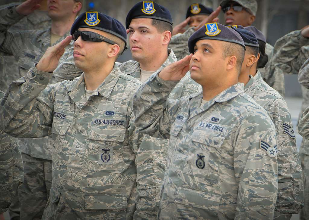 Airmen render a salute as the American flag is raised - NARA & DVIDS ...