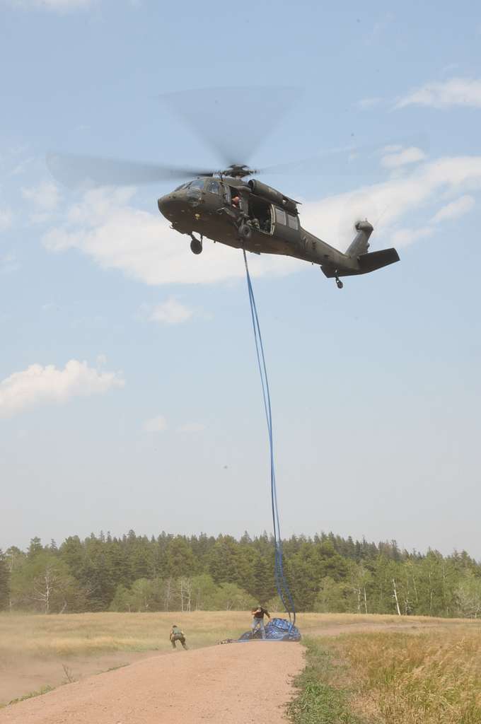 Using a UH-60 helicopter equipped with a hoist and - NARA & DVIDS ...