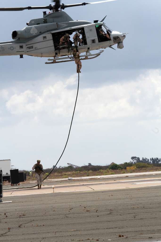 https://cdn2.picryl.com/photo/2012/10/12/marines-fast-rope-to-the-ground-from-a-hovering-uh-1y-613a43-1024.jpg