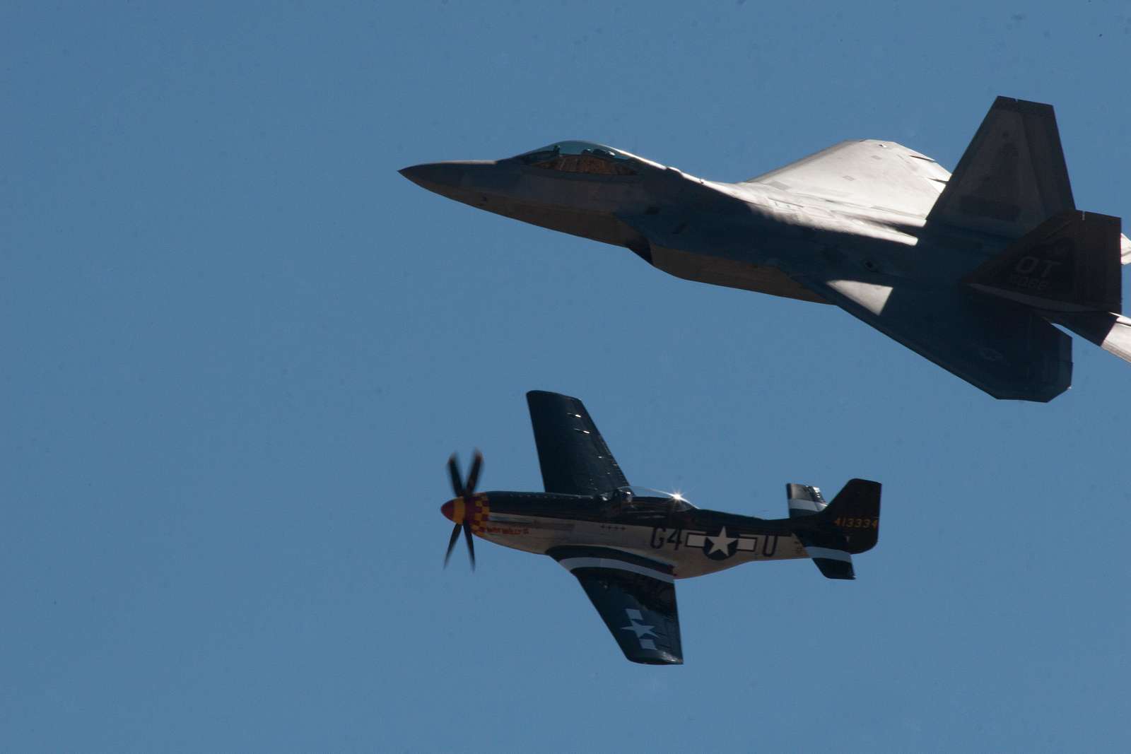 An F/A-22 Raptor flies alongside a P-51 Mustang during - NARA & DVIDS ...