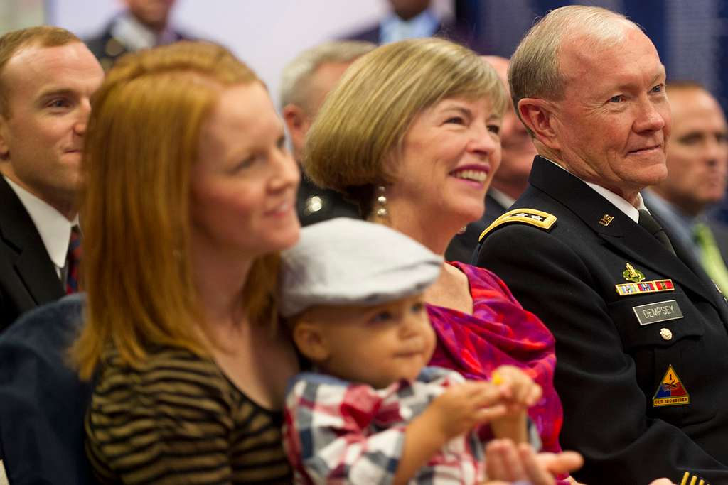 Army Chief of Staff Gen. Raymond T. Odierno, wearing a Navy football jersey,  poses with the