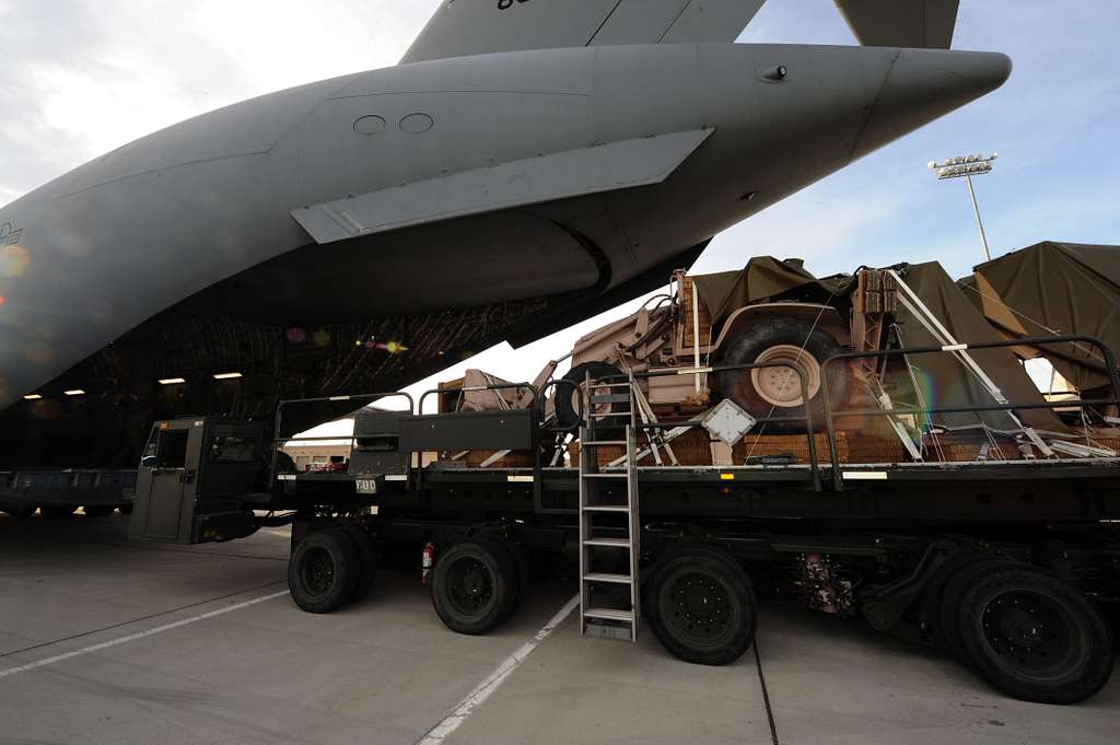 A backhoe from the 820th RED HORSE Squadron is loaded - PICRYL Public ...