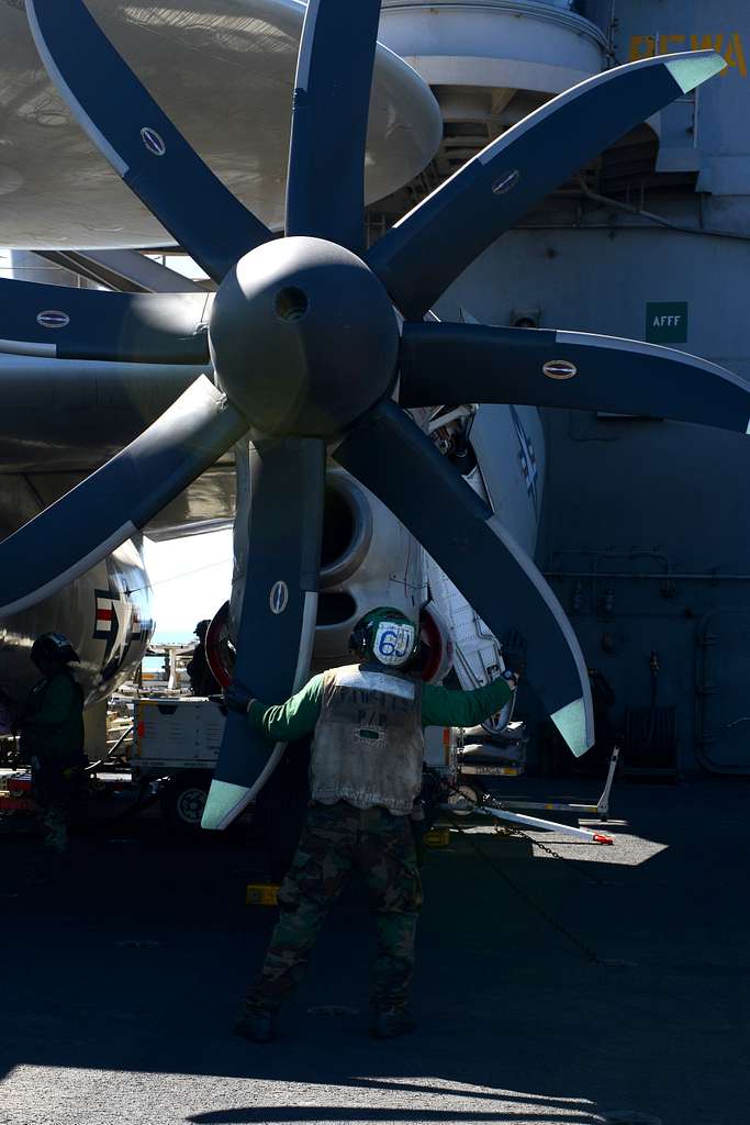 An U.S. sailor inspects the propeller blades on an - PICRYL