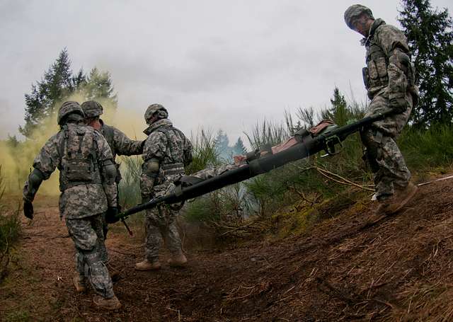 Army Pfc. Steven Williams throws a grappling hook to check for booby-traps  before crossing a