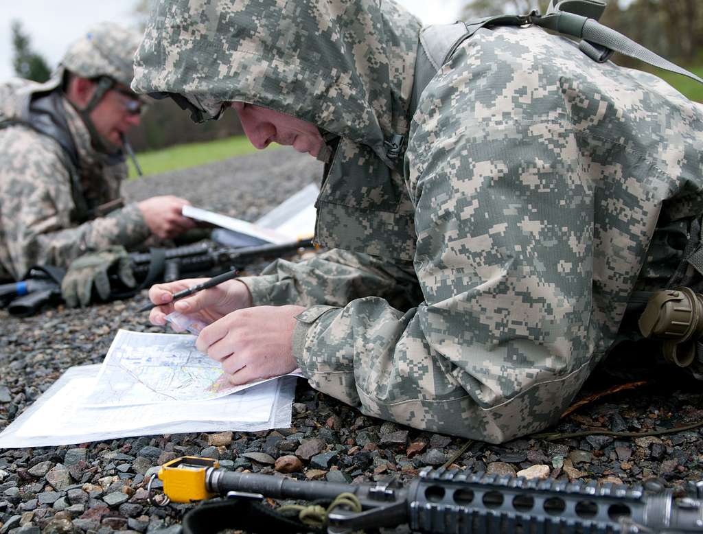 Army Pfc. Steven Williams throws a grappling hook to check for booby-traps  before crossing a