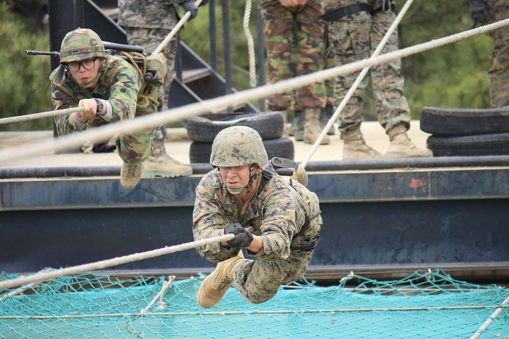 A ROK Marine and a U.S. Marine cross a one-rope bridge - PICRYL