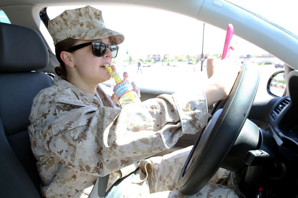 A Marine Demonstrates Multiple Distractions While Driving. - NARA ...