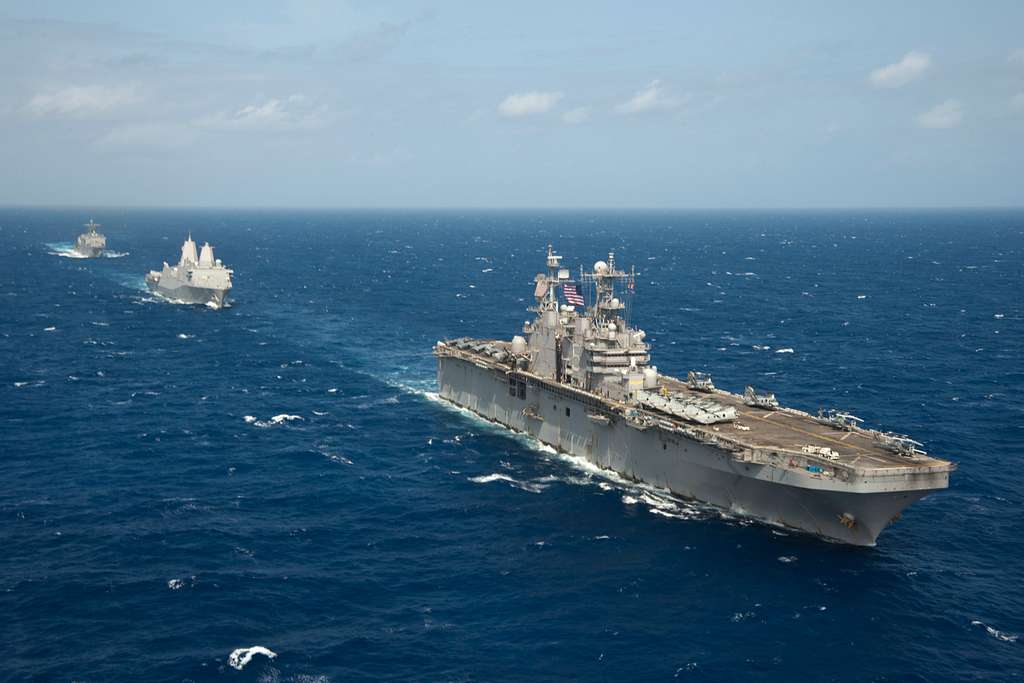 The amphibious assault ship USS Peleliu (LHA 5) leads - PICRYL - Public ...