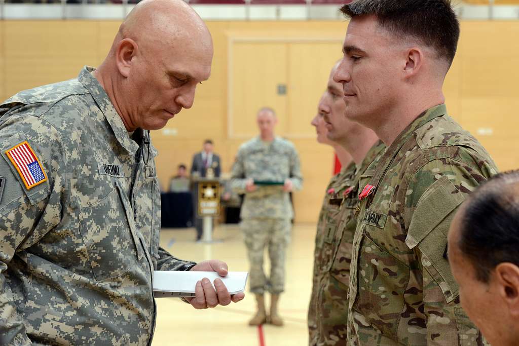 Army Chief of Staff Gen. Ray Odierno stands next to the umpire