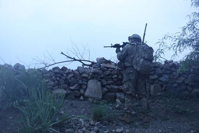 U.S. Army Staff Sgt. Angel Cotte, safety for primary Jumpmaster from Echo  Co.1-507th Airborne Infantry Battalion demonstrates correct static line hook-up  procedures during sustained Airborne training in preparation for the 75th  Anniversary