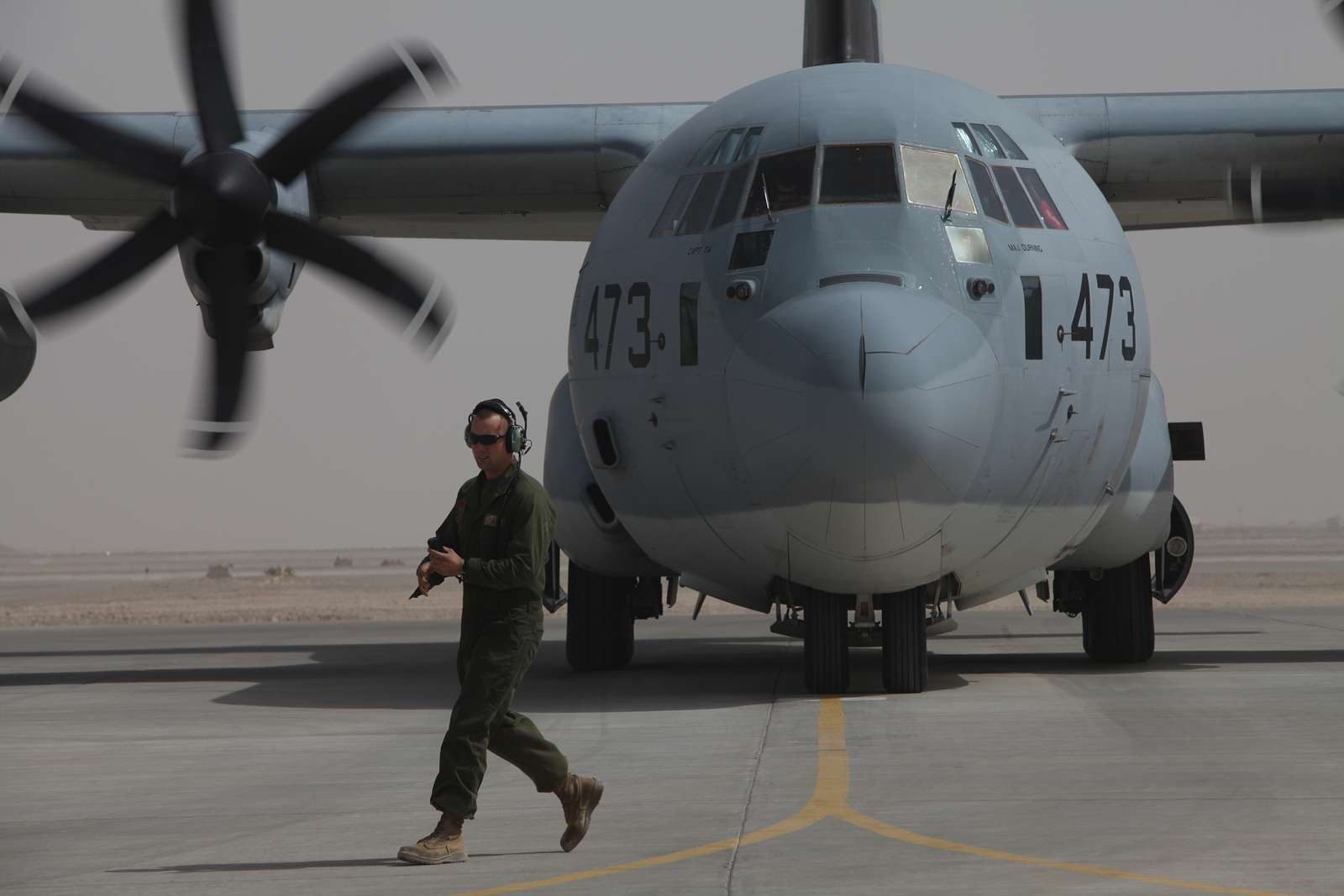 A 37th Tactical Airlift Squadron C-130E Hercules aircraft makes a grass  strip landing at Drop Zone Juliet near Aviano Air Base during an evening  training mission. Country: Italy (ITA Stock Photo 