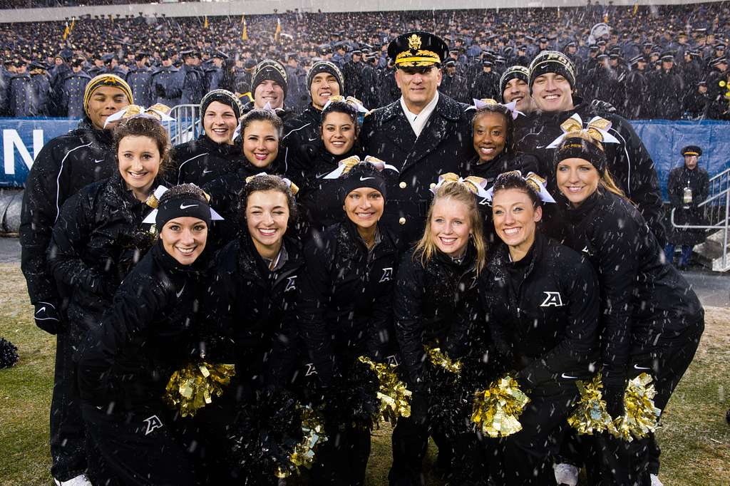 Army Chief of Staff Gen. Raymond T. Odierno, wearing a Navy football jersey,  poses with the