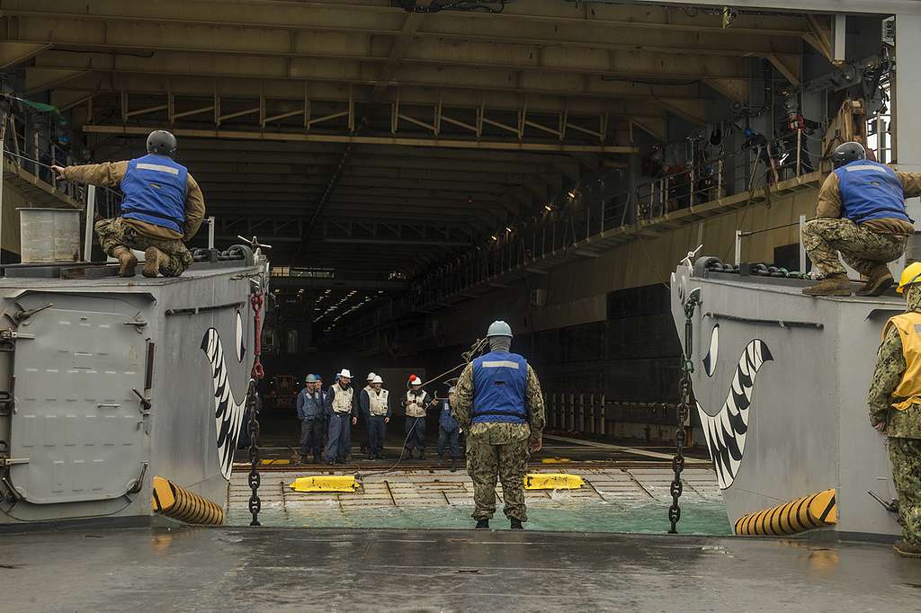 A line is thrown from the amphibious dock landing ship - NARA & DVIDS