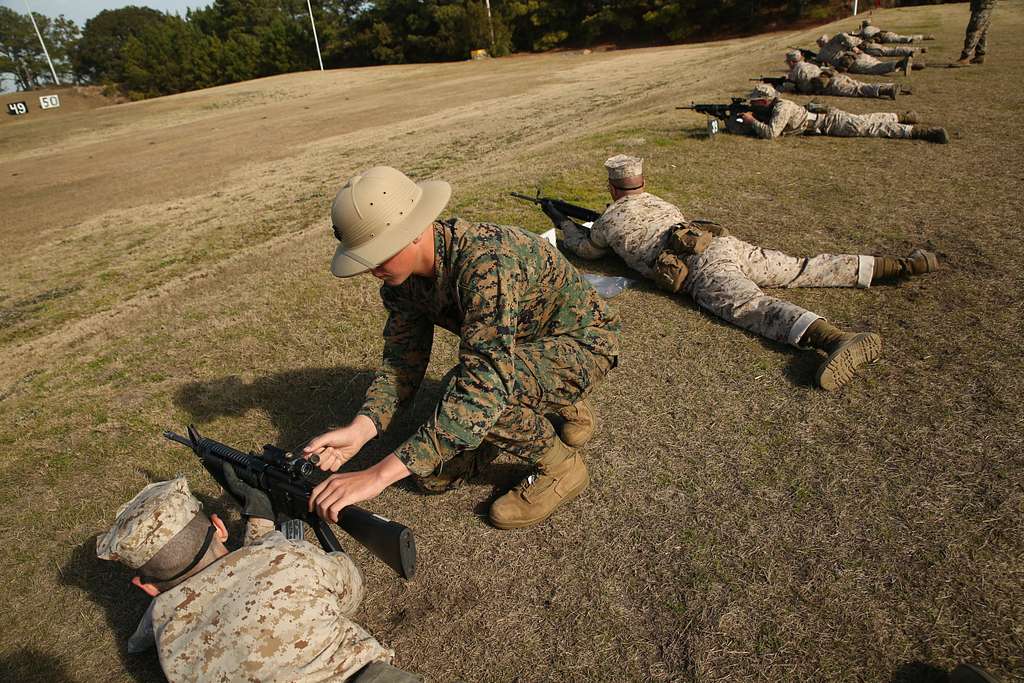 Lance Cpl. Joseph Magowan, a marksmanship coach, assists - NARA & DVIDS  Public Domain Archive Public Domain Image