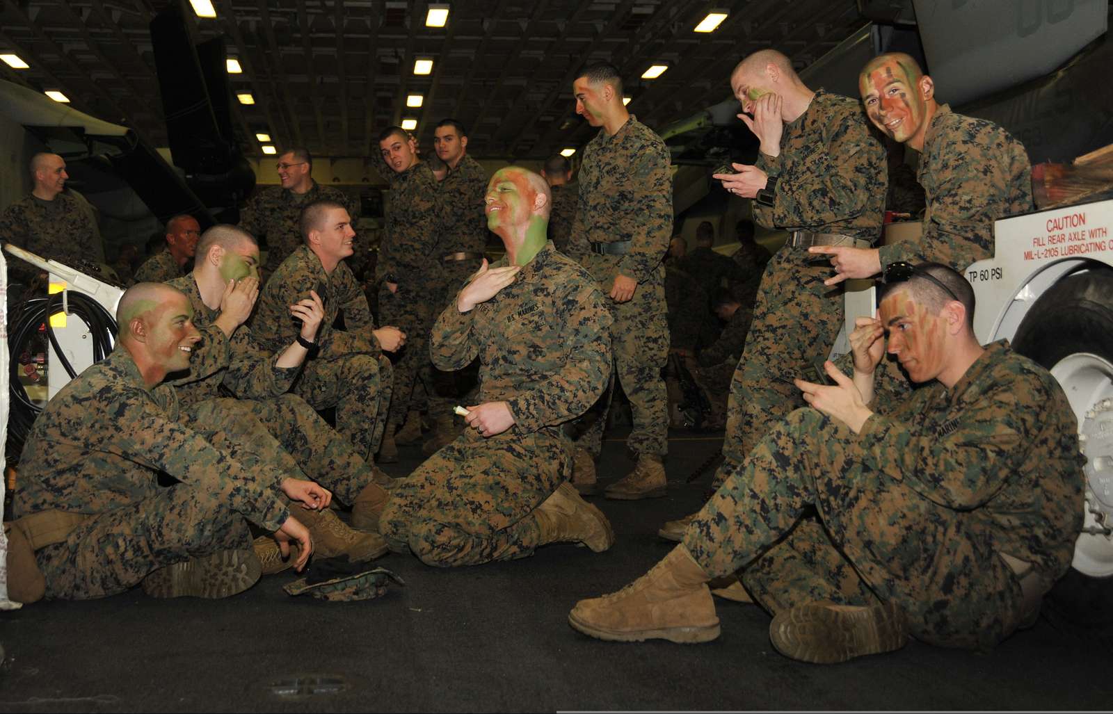 Marines aboard the USS Bataan (LHD 5) apply face paint - NARA & DVIDS