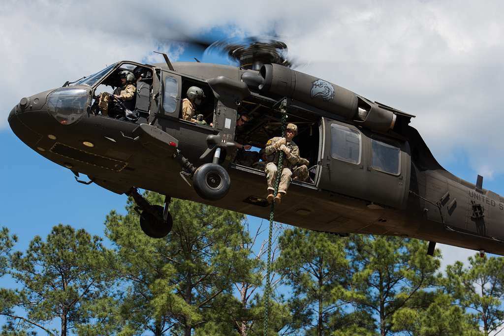 U.S. Army Rangers fast rope from a helicopter in preparation
