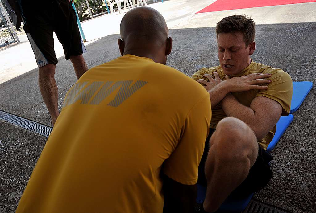 A Sailor performs curl ups during the semi annual Navy PICRYL