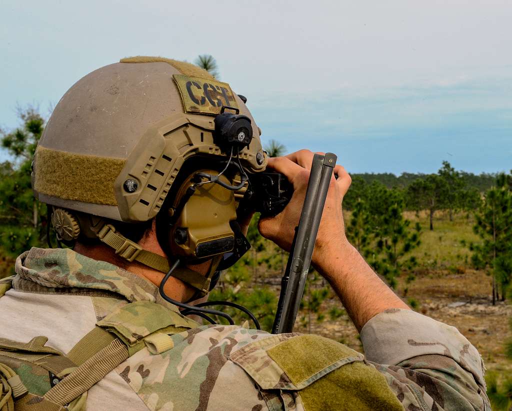 A U.S. Air Force combat controller looks through binoculars - NARA ...