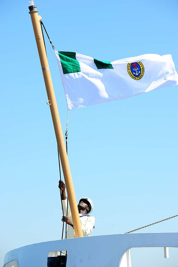 A member of the Nigerian navy raises the Nigerian naval - PICRYL